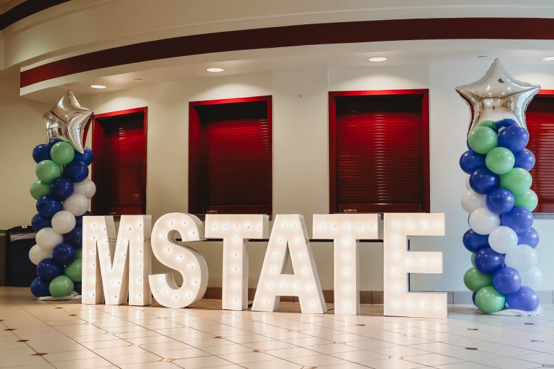 M State lighted floor sign